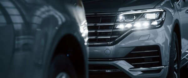 powerful-headlights-particle-view-modern-luxury-cars-parked-indoors-daytime