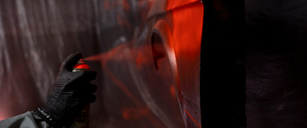 side-view-hand-spraying-powder-paint-door