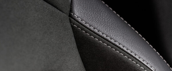 High angle view of modern car fabric seats. Close-up car seat texture and interior details. Detailed image of a car pleats stitch work.