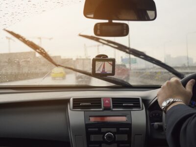 Business man is driving a car in raining day with moving wiper blades